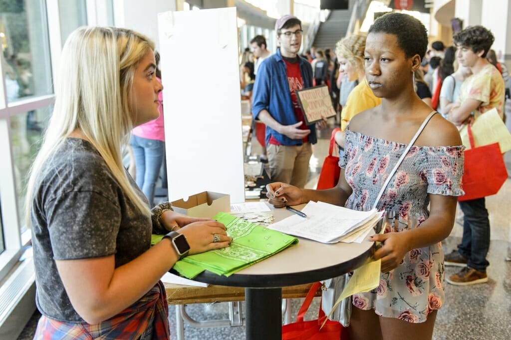 Kenya Link (left) talks with Princess Vaulx (right) at the National Alliance on Mental Illness booth during the Student Organization Fair.