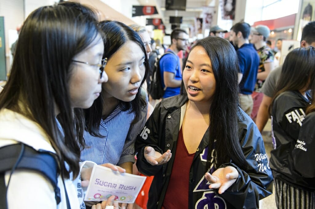 Panouly Moua (right) talks with students about the Alpha Kappa Delta Phi sorority.