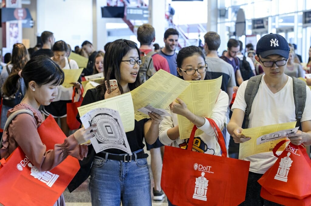 Students check their maps and student organization lists.