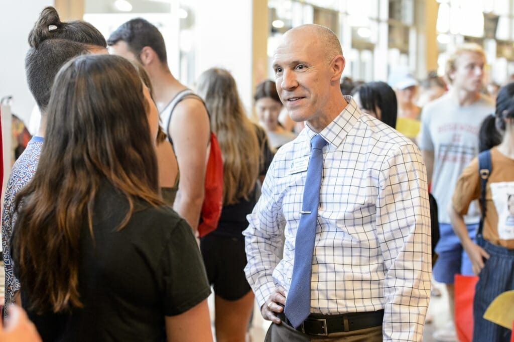 Interim dean of students Argyle Wade (right) talks with a student during the Student Organization Fair.