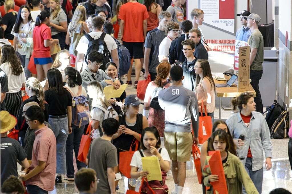 Students walk through the Kohl Center during the Fall Student Organization Fair.