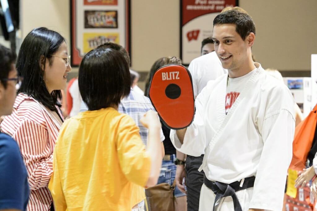 Students check out the UW Japanese Karate Club booth.