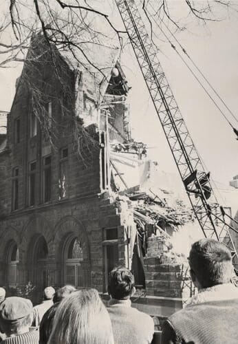 Photo: Wrecking ball swinging into partially demolished building