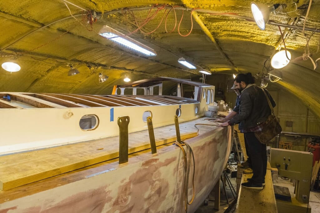 A photo of Parr as he wrote a story on the restoration of a 1960s sailboat for the Peninsula Pulse. 