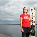 Gabbie Taschwer stands on a dock, holding her water skis, with Lake Mendota in the background.