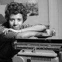 Photo: Lorraine Hansberry leaning on a typewriter in her apartment