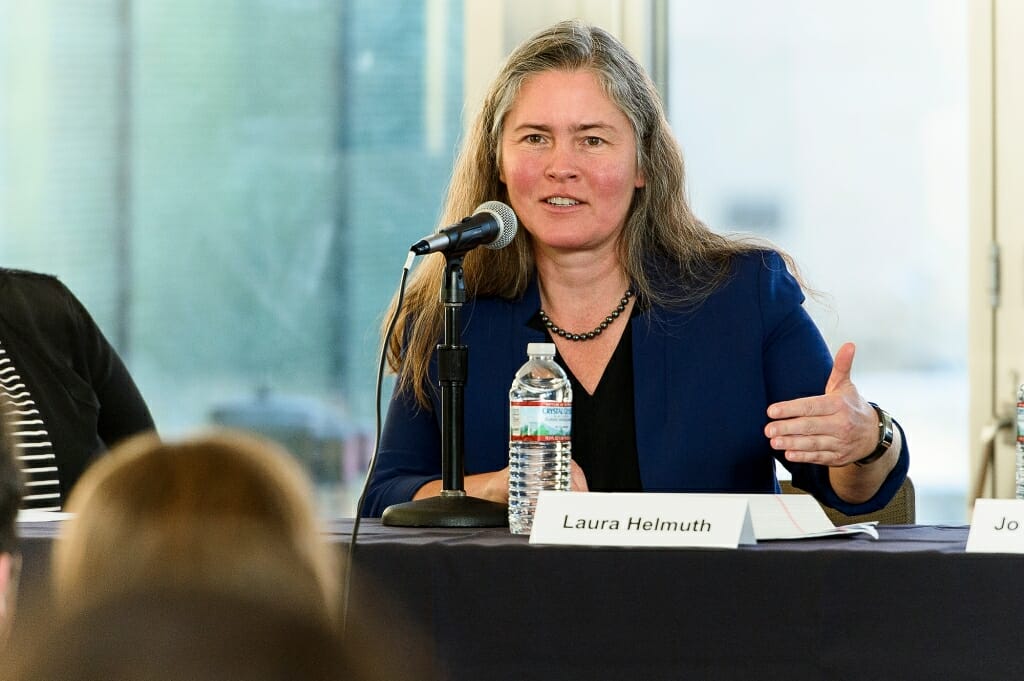 Helmuth gesticulates while speaking to an audience.