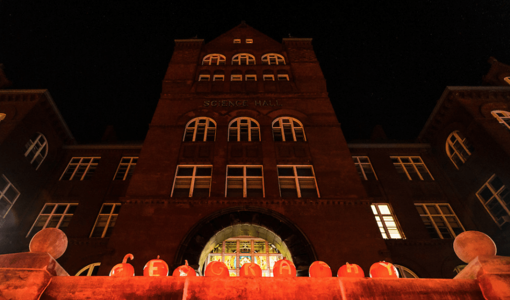 A row of displayed pumpkins -- each carved with a letter -- spell out the word "geography" outside Science Hall at the University of Wisconsin–Madison during a pre-Halloween, autumn night on Oct. 28, 2016.