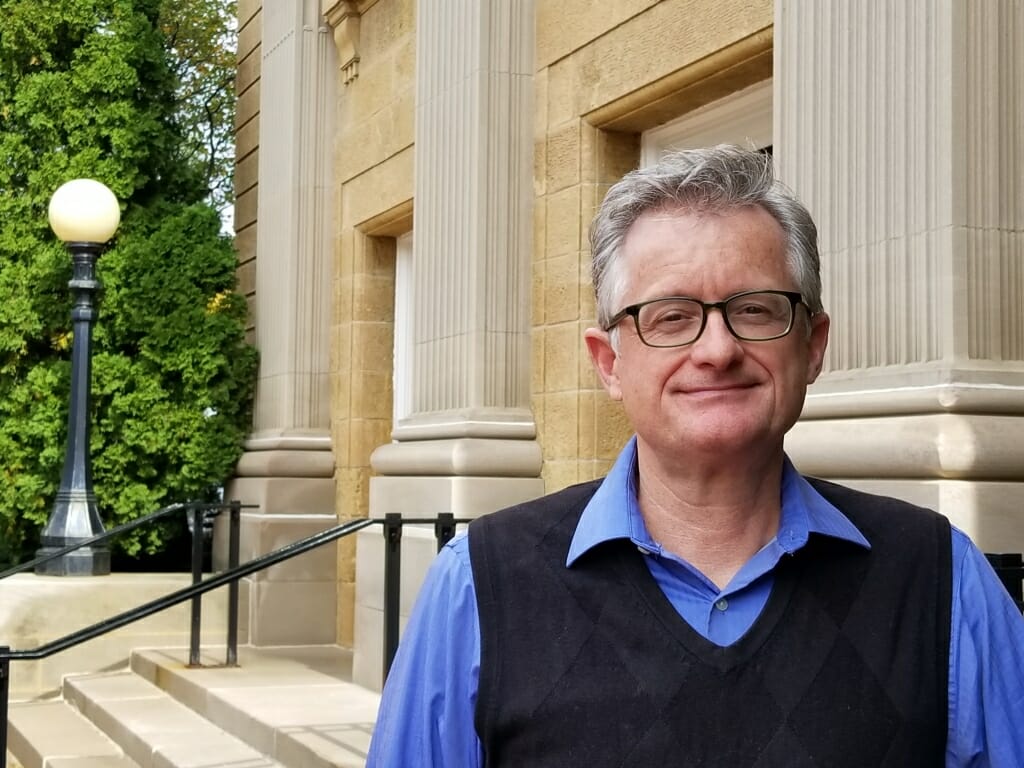 Photo: Tim Walsh standing in front of rear entrance to Bascom Hall