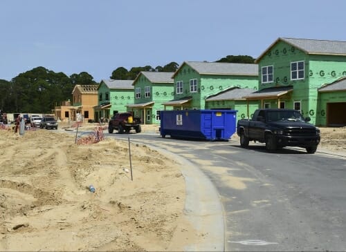 Photo: Houses under construction with street in foreground