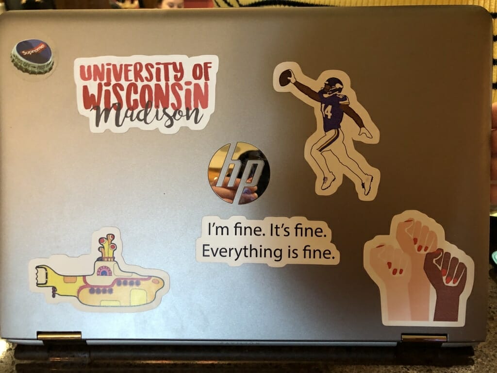 Freshman Julia Glaeser's laptop, which features a UW one, a Supreme bottle cap, a Minnesota Vikings sticker, and a Beatle's Yellow Submarine sticker, among others. 