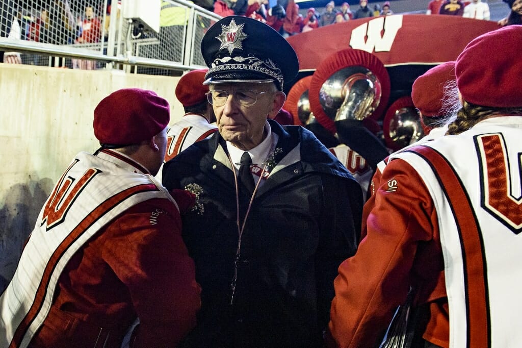 Leckrone shakes hands with members of the band as they leave the field at his final UW home football game.