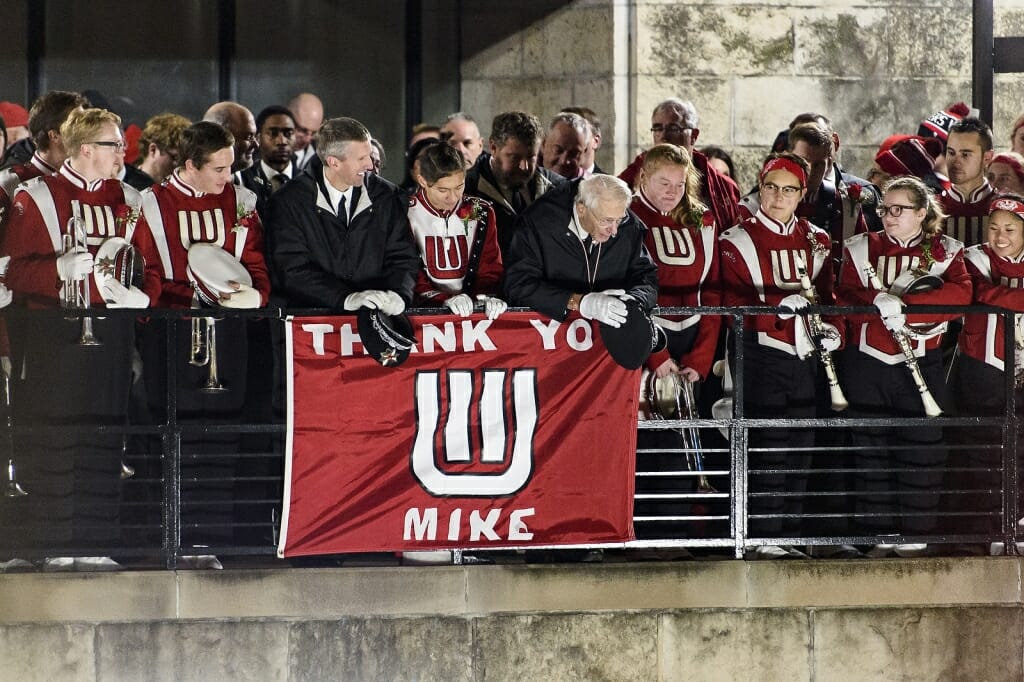 UW-Madison marching band director Mike Leckrone shakes hands and talks with former members of the band inside the courtyard of the Mosse Humanities Building following his final home football game on Saturday. 