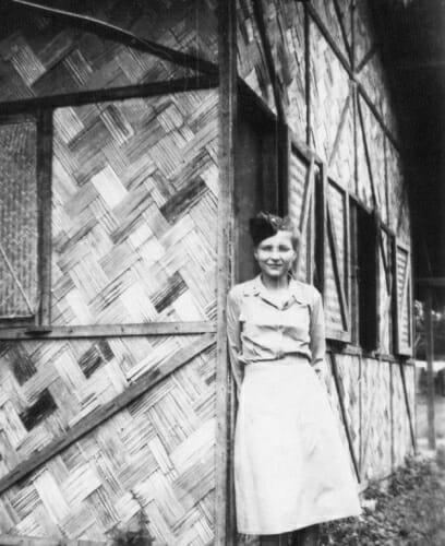 Black and white photo of Signe Skott Cooper in front of her basha, the nurse’s living quarters at the military hospital in India. It had four rooms for eight nurses with a latrine a half block away.