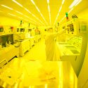 Photo of Umesh Patel, research associate in the McDermott Group in the University of Wisconsin-Madison Department of Physics working in a clean room in the Wisconsin Center for Applied Microelectronics in the Engineering Centers Building.