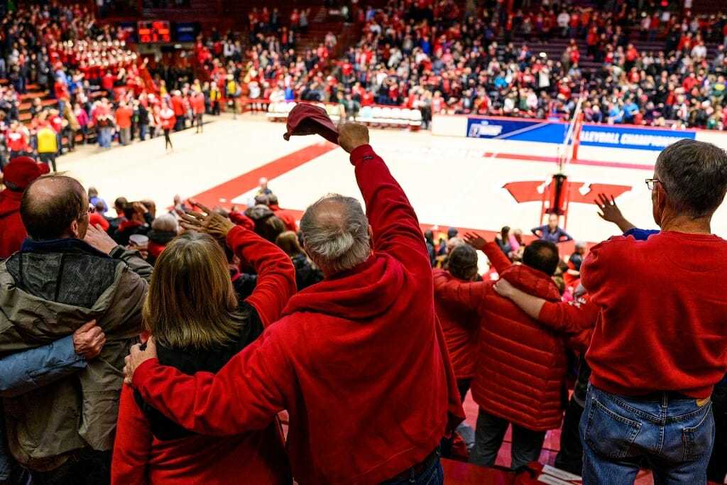 Badger fans link arms and sing 