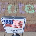 Student volunteers chalked reminders to students to vote at campus polling places on Election Day.