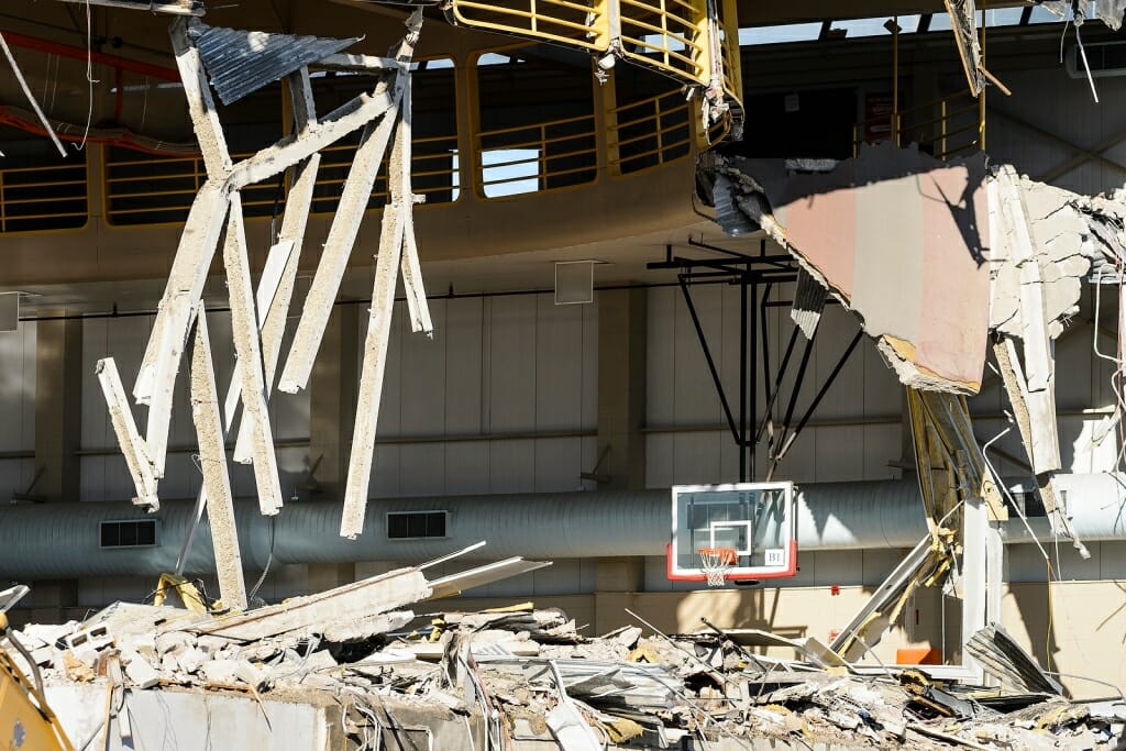 Photo: Debris from demolished gymnasium with basketball hoop still standing