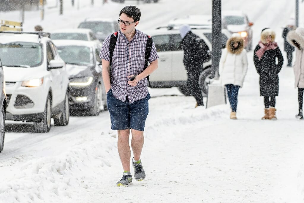 Photo: Student walking in shorts and short-sleeve shirt in snow