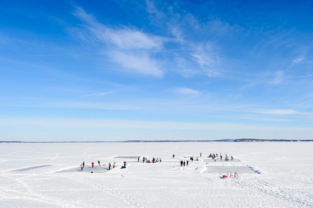 Photo: People playing hockey on frozen lake