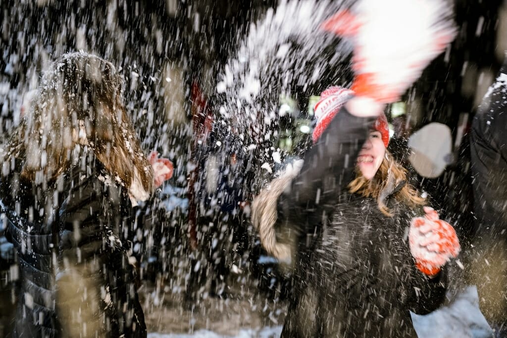 Photo: Snow flying all around a student's smiling face