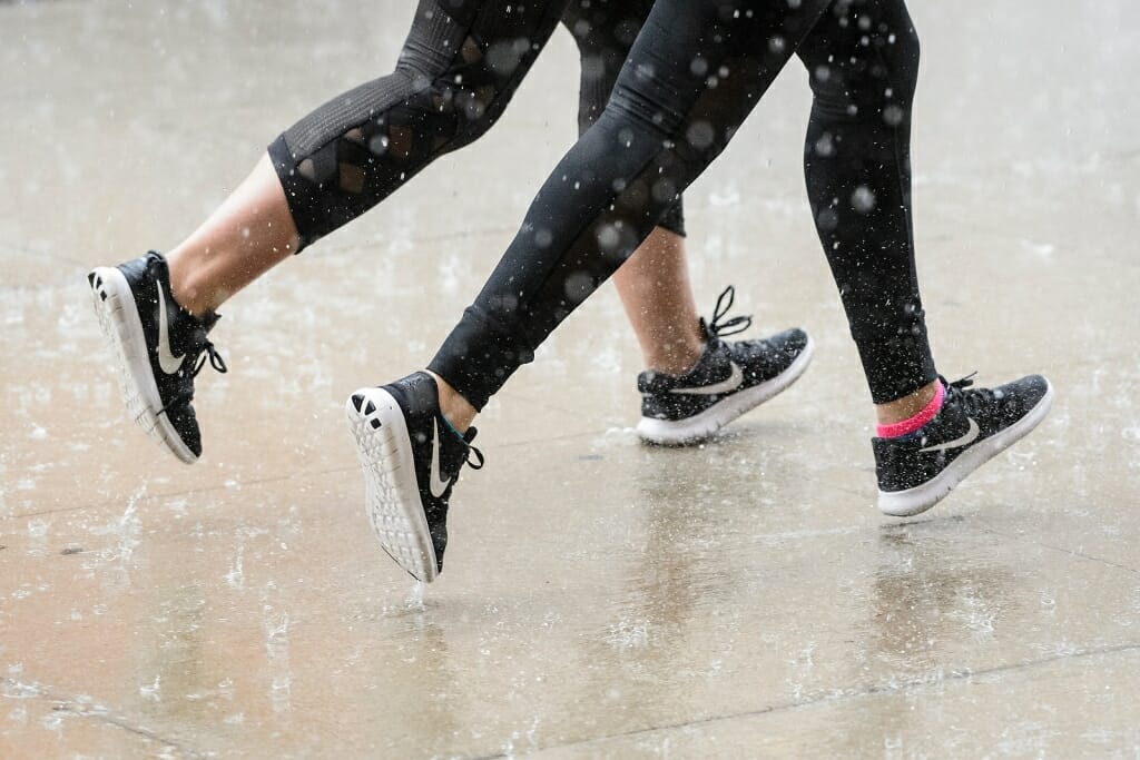 Photo: Closeup of legs of joggers moving in unison