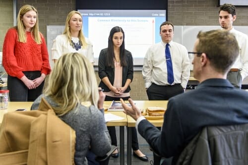 Students listen to feedback from the panel