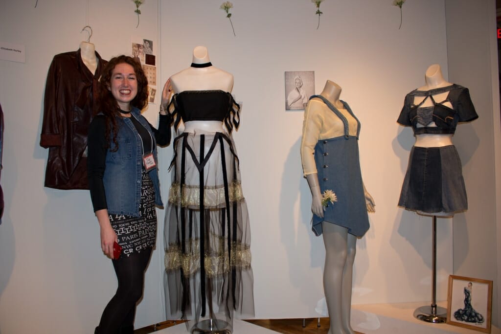 Photo: A woman with the dresses she designed.