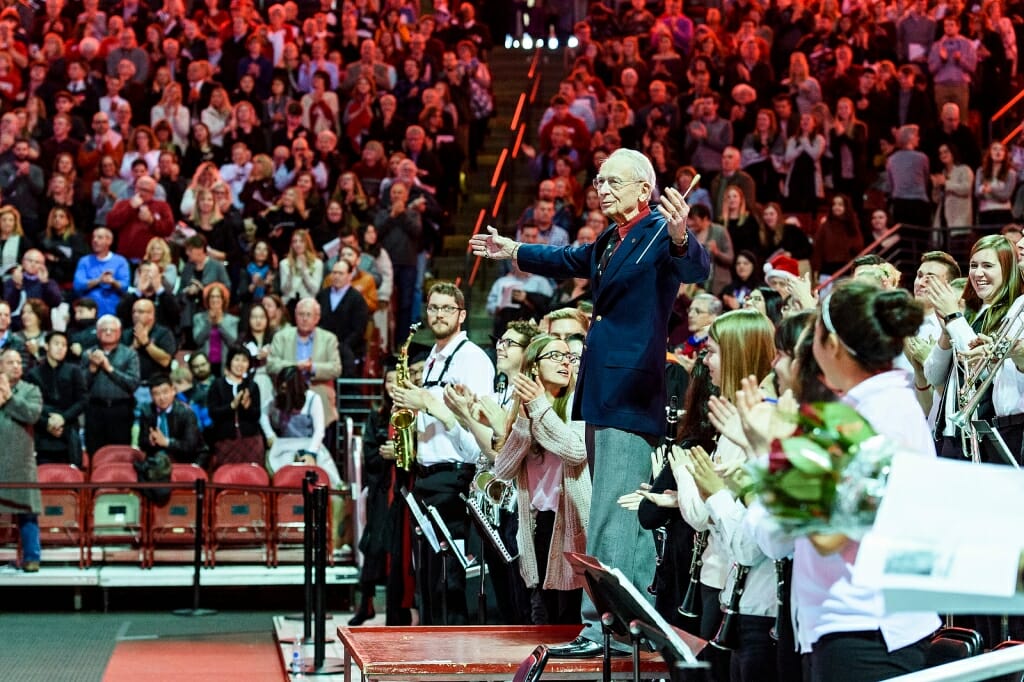 Photo of UW Band Director Mike Leckrone receiving a standing ovation from the crowd.