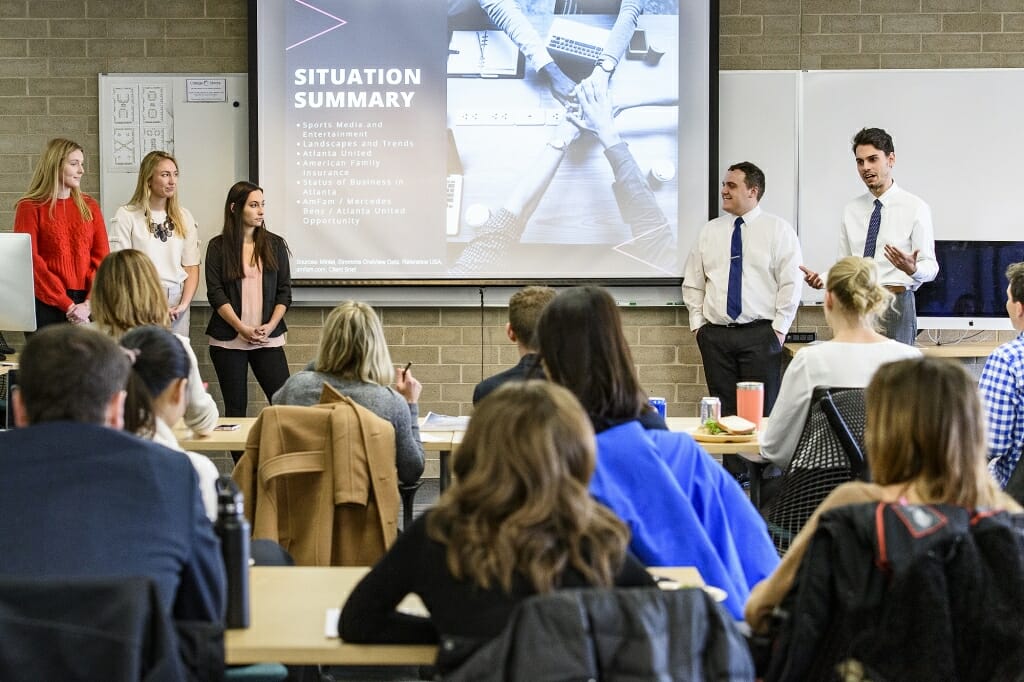 Photo: A group of students addresses a class.