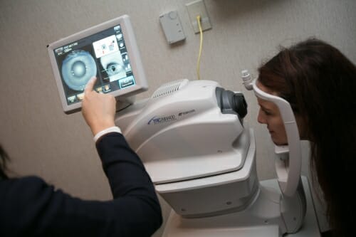 Photo: A computer screen with a medical image on it, someone is pointing to it.