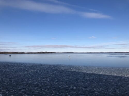 Photo: People ice skate on frozen Lake Mendota.