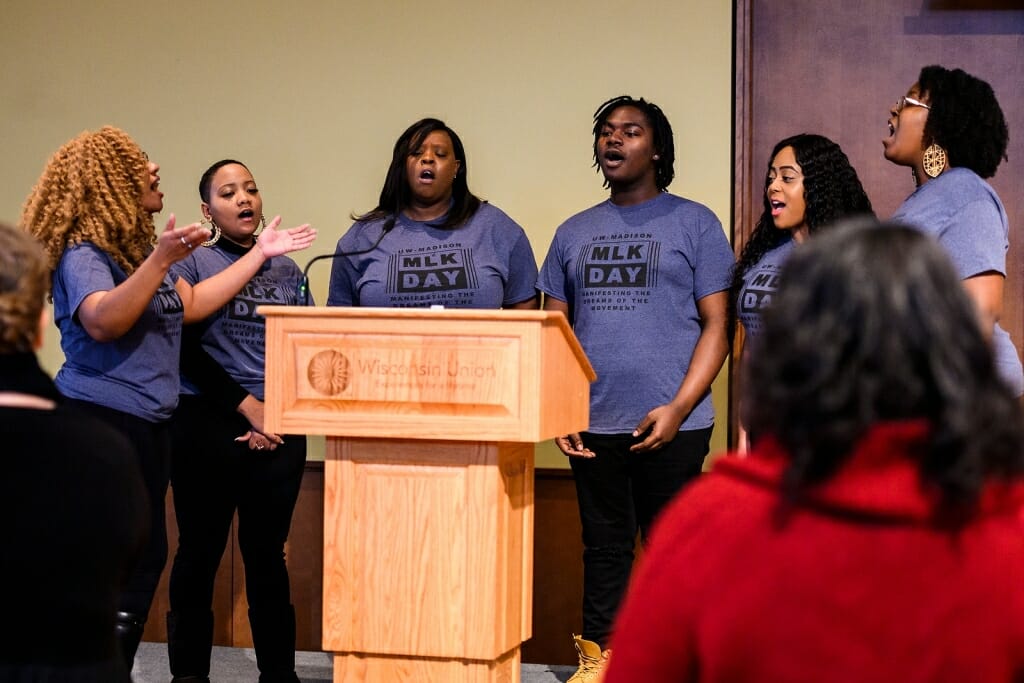 Photo: A group of teenagers sing at the podium.