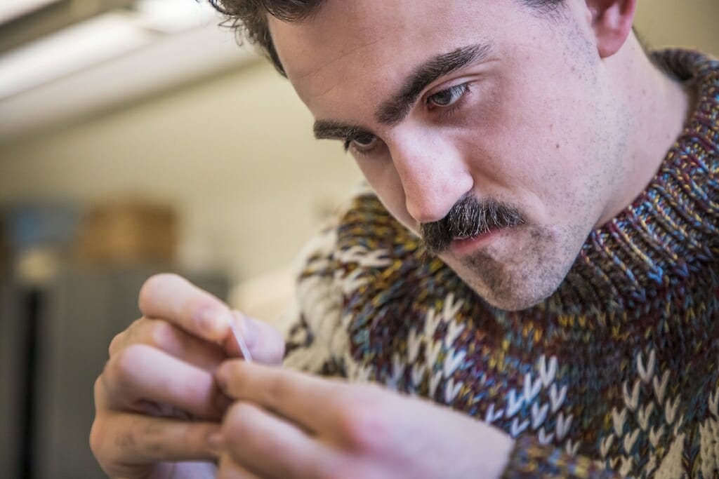 Photo: Griffin Claes working on a sewing project