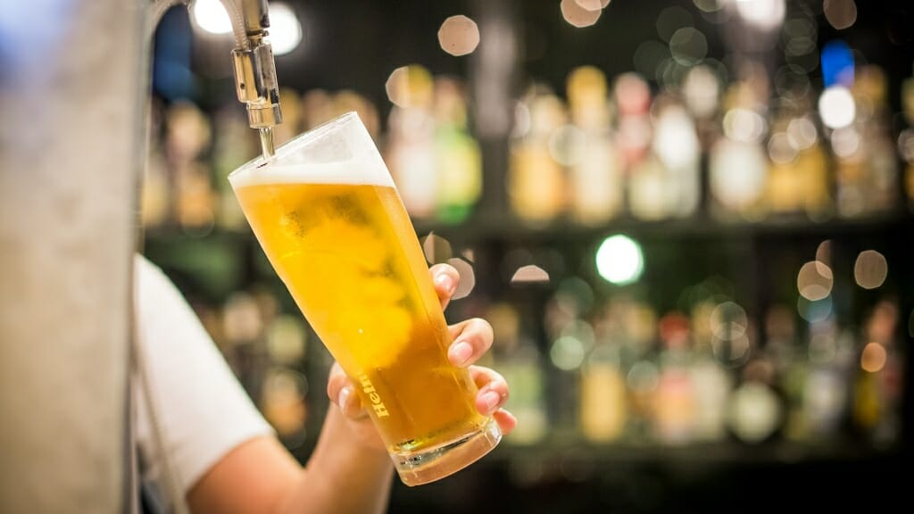 Photo: Bartender tapping a glass of beer