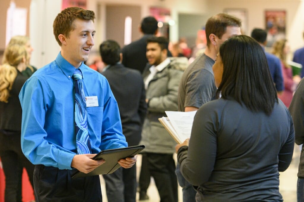 UW School of Business undergraduate James Nejedlo (left) talks with a recruiter.