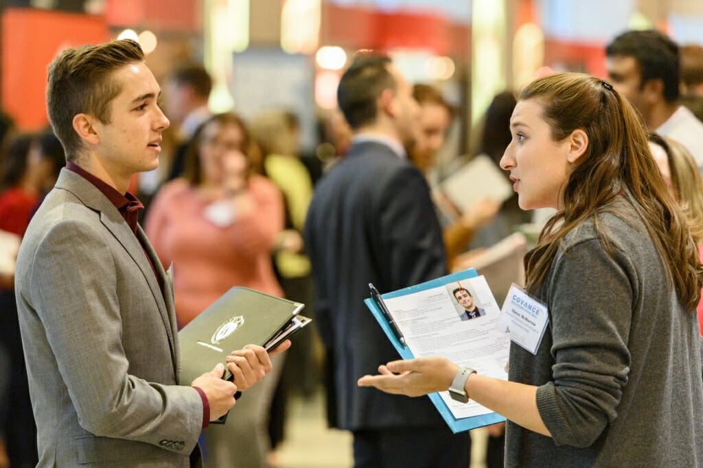 UW undergraduate Jacob Zabel talks with  recruiter Stacey McMorrow from Covance. The fair featured 215 employers and was open to all current students and alumni. 