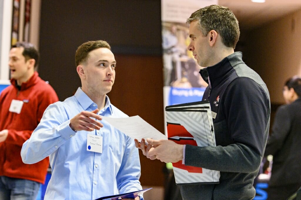 UW undergraduate Nathan Kersten (left) talks with a recruiter from UW Credit Union.