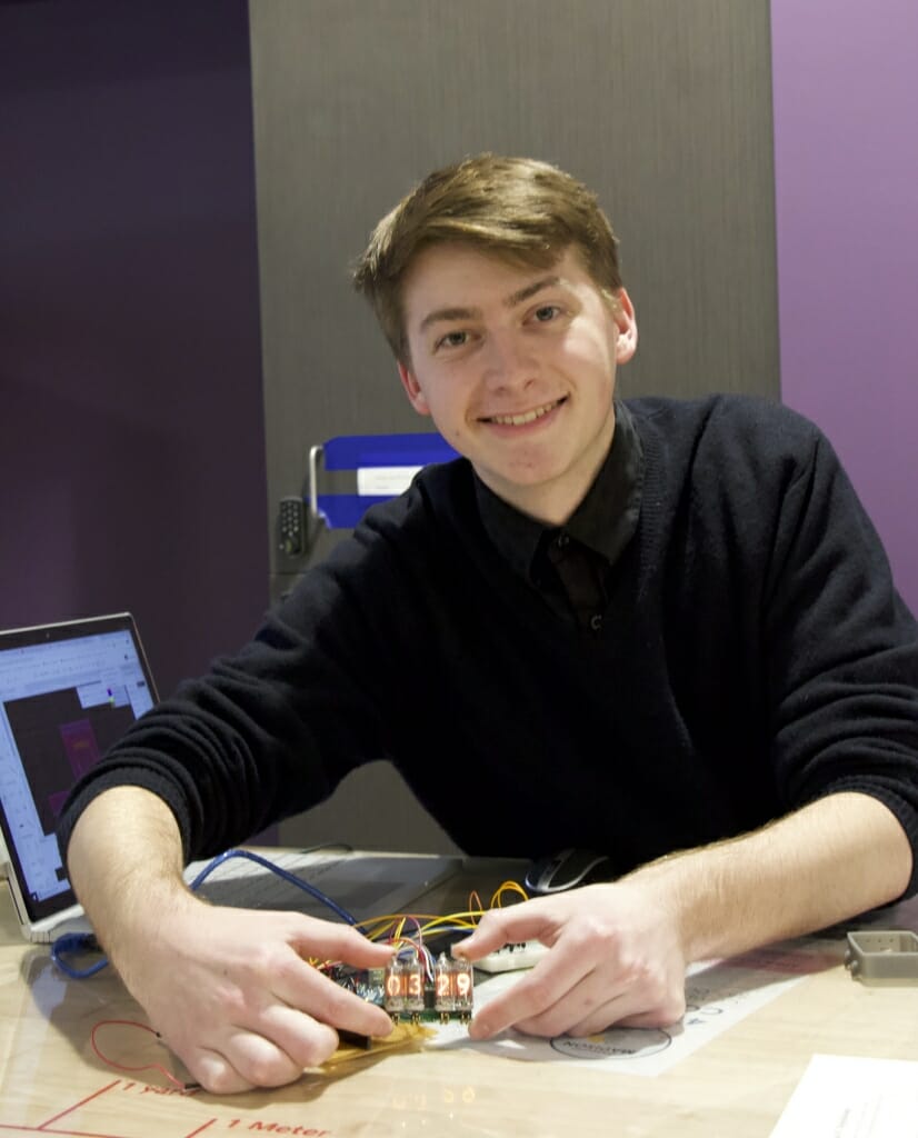 Photo: A student shows off his watch invention.