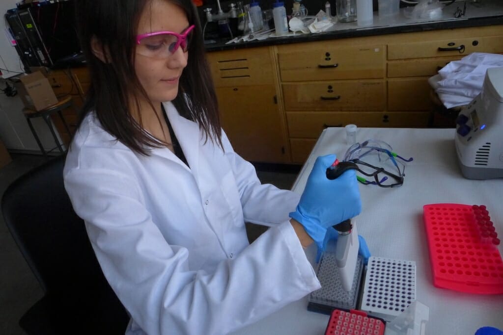 Photo: A woman works in a laboratory.