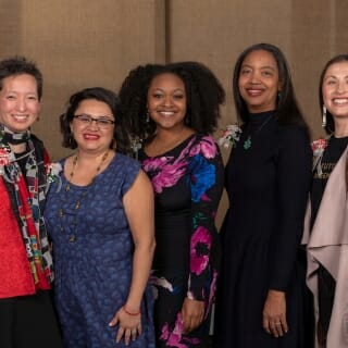 Photo: Five women pose for a photo.