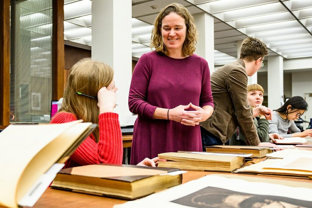 Photo: Anna Andrzejewski standing talking to seated students