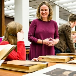 Photo: Anna Andrzejewski standing talking to seated students