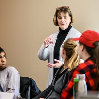 Photo: Bratzke standing and gesturing to seated students