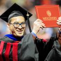 Photo: PhD graduate holding diploma cover