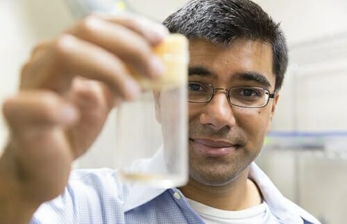 Photo: Sharma holding a vial in his hand