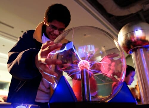 Photo: Student touching clear globe