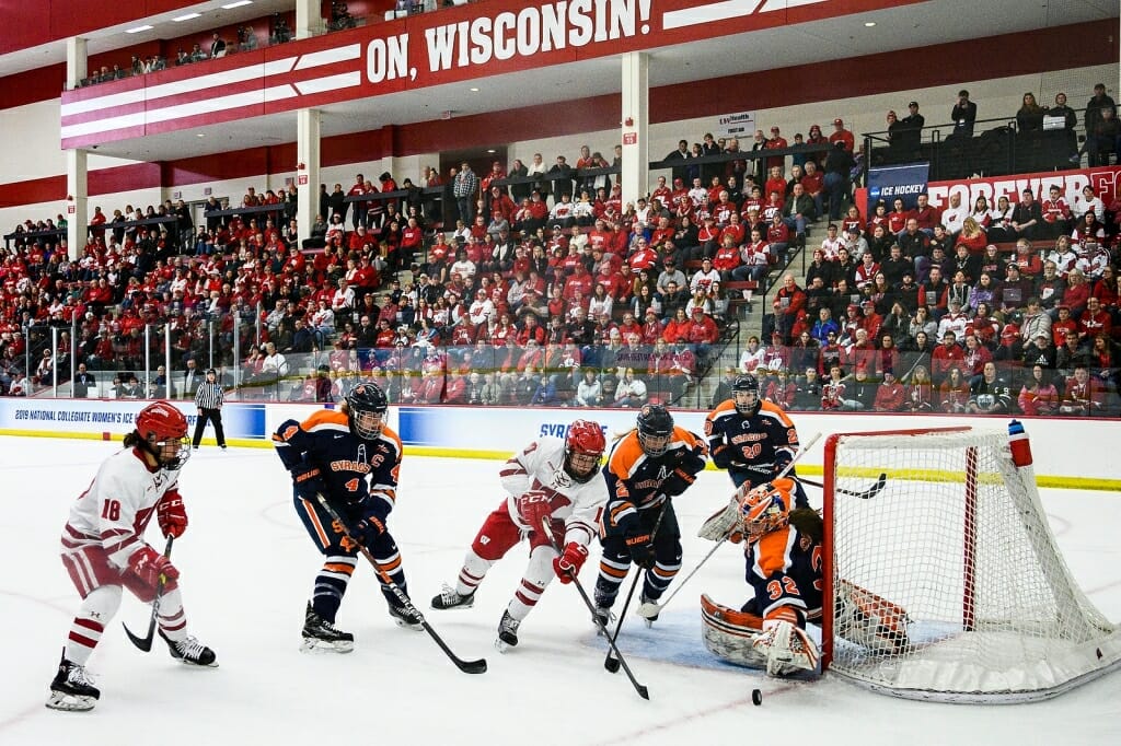 Badgers Abby Roque (18) and Britta Curl (17) charge the net against the Syracuse Orange.