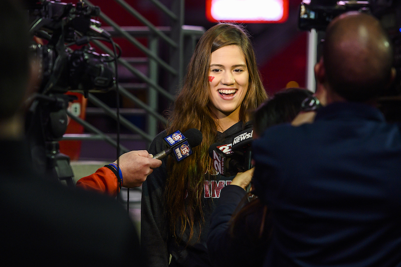 Photo of swimmer Beata Nelson speaking to reporters.