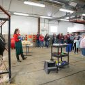 Photo: In a cattle barn with cow visible, an instructor talks to about a dozen students.